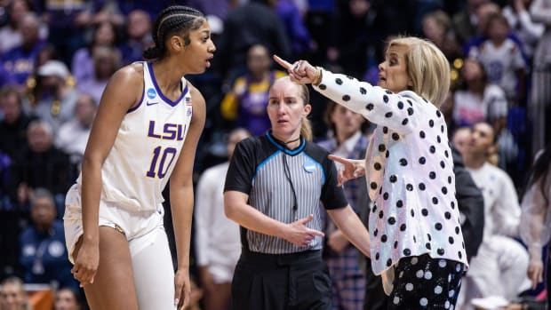 Tigers head coach Kim Mulkey gives directions to forward Angel Reese while playing Michigan.